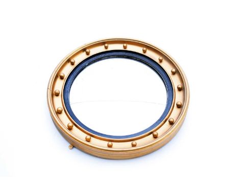 A Regency style giltwood convex wall mirror, with reeded ebonised sight, the frame applied with balls, 63cm dia, together wit