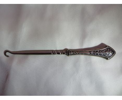 A sterling silver handled button hook.