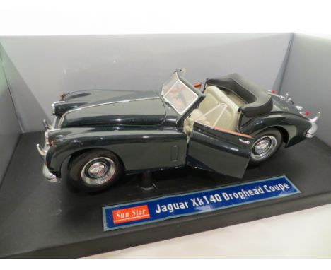 A Jaguar XK140 Drophead Coupe die cast metal model car by Sun Star. Scale 1:18.