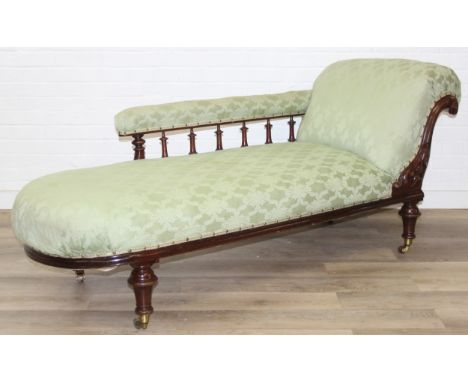 A Victorian green upholstered chaises longue with turned details and legs, three of the brass socket casters stamped Cope’s p
