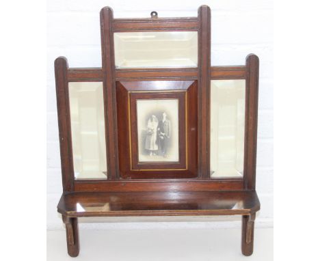 An antique Edwardian mahogany wall shelf with bevelled-edged mirror, display shelf and central photograph area, 45cm W x 60cm