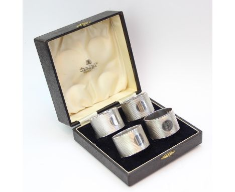 [177.17g] - a boxed set of four silver napkin rings, heavy gauge engine turned silver with initial F, each marked for Sheffie