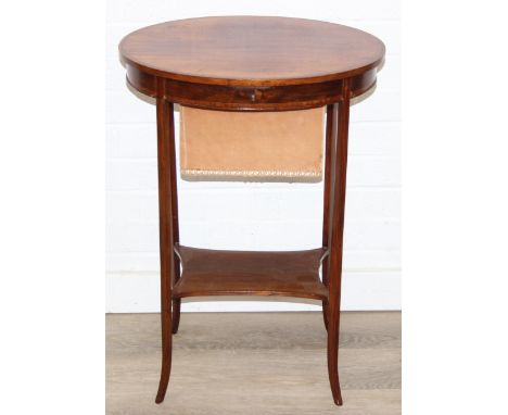 An Edwardian mahogany sewing table of oval form, with lift up top and fabric basket, 49cm x 35cm x 70cm
