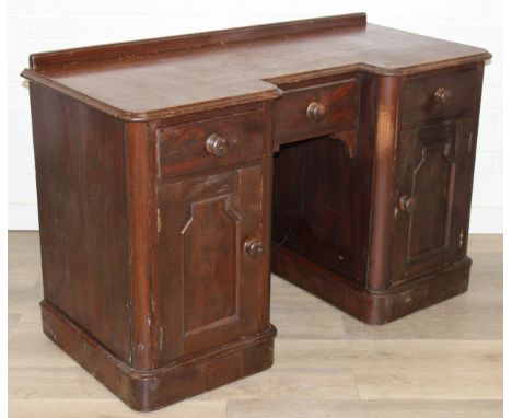 A 19th century mahogany desk with three drawers and two cupboards, approx 120cm x 54cm x 74cm