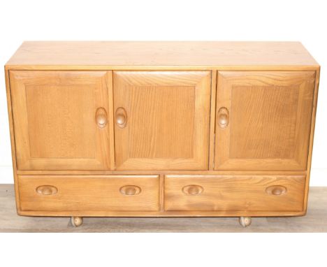 A retro Ercol Windsor model 468 sideboard, three cupboards over two drawers, blonde finish, 128cm x 44cm x 77cm