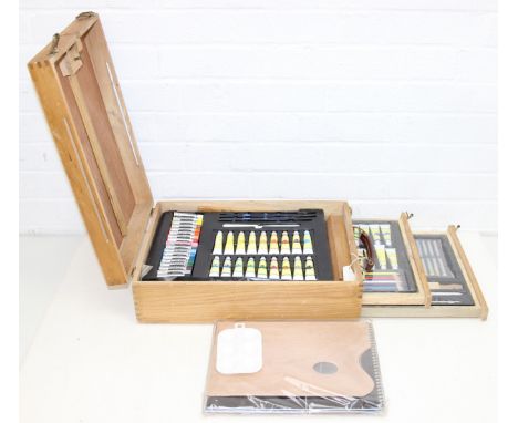 A vintage wooden artists easel box and contents, seemingly unused