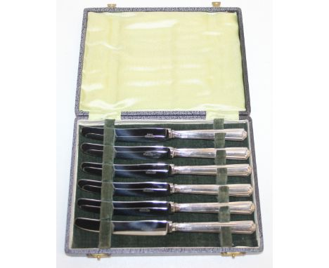 A boxed set of six Art Deco style silver handled knives, marked for Sheffield 1950, presented in box, each knife 18cm long