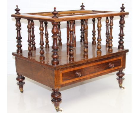 A 19th century walnut Canterbury or magazine rack with single drawer, turned supports and brass and ceramic castors, 55cm x 4