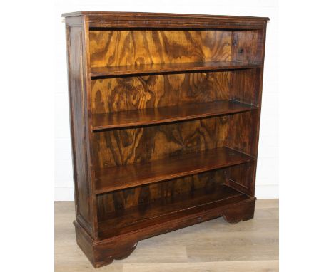 A vintage bookcase with three shelves and paneled sides, unknown wood with prominent grain, possibly oak, 107cm x 28cm x 122c