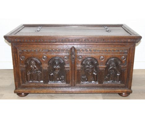 An unusual antique carved oak trunk or coffer depicting the four evangelists or gospels, possibly Italian with interesting lo