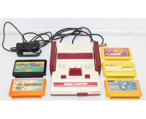 Vintage Nintendo Family Computer 'Famicon' console with 2 control pads and a selection of games to incl Yoshi's Cookie, Super