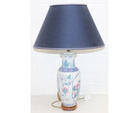 Chinese style lamp and blue shade, lamp base decorated with blues and pinks, on wooden base, 73cm incl shade