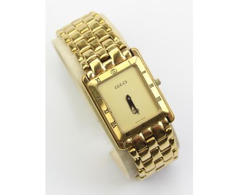 Gucci - a vintage gold plated quartz wrist watch, the gold coloured rectangular plain dial with Roman numerals to the bezel, 