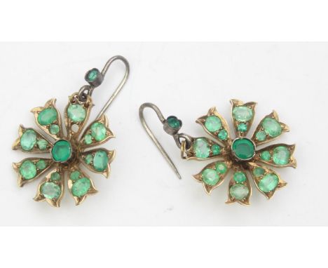 A pair of antique earrings set with emeralds in a floral cluster, the metal unmarked but XRF testing around 10ct gold, likely