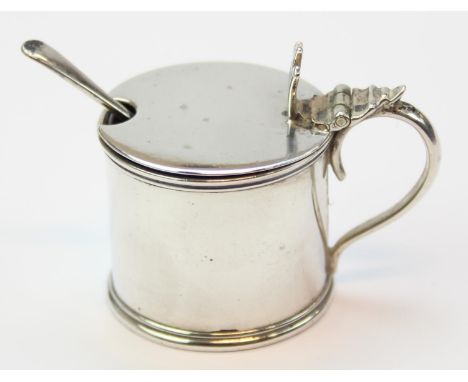A small silver drum mustard pot with matching spoon and blue glass liner, Chester 1909 by Stokes &amp; Ireland, 47mm tall, 43