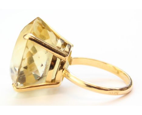 [12.99g, P] - a large 18ct gold and yellow stone cocktail ring, the stone believed to be a yellow topaz set within an 18ct go