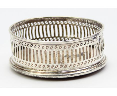 A vintage silver wine bottle coaster with pierced decoration, London 1978 by Mills &amp; Hersey, 9.5cm in diameter