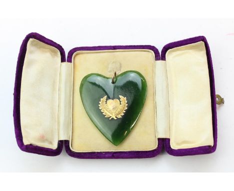 A vintage 9ct gold mounted and greenstone pendant formed as a heart, believed to be a nephrite jade or Pounamu originating fr