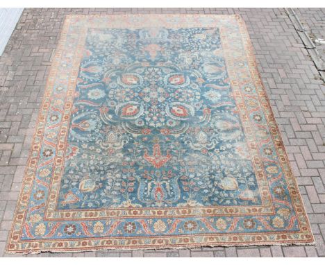 A large vintage Perisan rug, believed to be a Tabriz, blue ground with red border, 380cm x 274cm