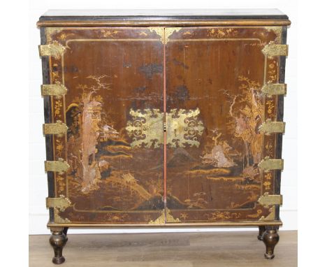 An unusual antique Japanese export lacquer cabinet, the doors from the early to mid Edo period (1615-1868) with engraved bras