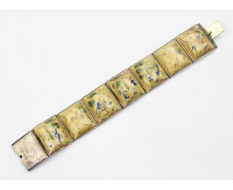 An unusual silver bracelet set with seven hand painted Mughal style bone plaques, possibly Indian, marked to clasp and XRF co