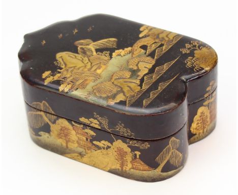 An antique Japanese lacquer box with gilt decoration, unusual lancet style shape, the interior containing a further three sma