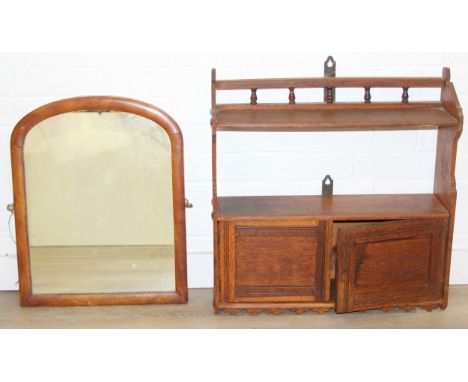 A small oak wall mounted cupboard and shelf unit, early 20th century, 58cm x 15cm x 60cm and a wall mirror with mahogany fram