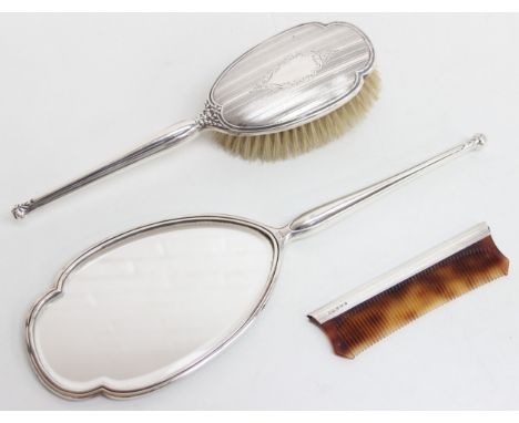 A silver backed hand mirror, brush and silver mounted comb, all pieces marked for Birmingham 1991 by Mappin &amp; Webb, the m