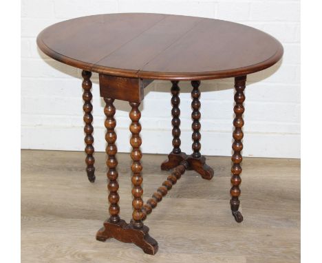 A small oak Sutherland table with bobbin turned legs, oval drop flap top, early 20th century, 73cm x 56cm x 57cm when open