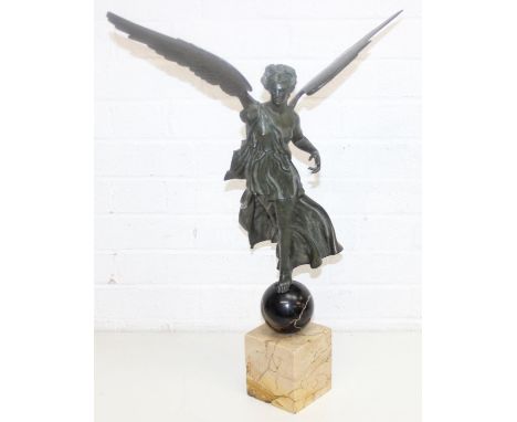 In the manner of Sabatino de Angelis & Fils, a large antique bronze depicting a winged female figure on sphere and yellow mar