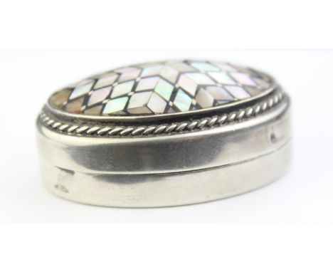 A Middle Eastern silver pill box with geometric mother of pearl inlay, Arabic 0.800 silver hallmarks and XRF confirmed, possi