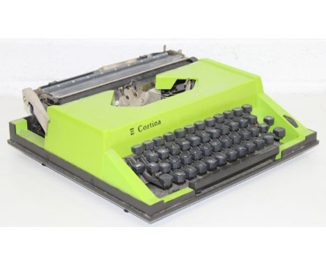 A vintage Cortina portable typewriter in case, unusual lime green finish, 34cm wide