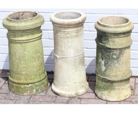 Three antique chimney pots to include two cannon design and one with impressed decoration, the largest 33cm diameter x 62cm t