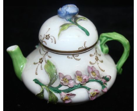An extremely rare 19th century squat pear shaped miniature teapot and cover, likely by Rockingham but unmarked, with colourfu