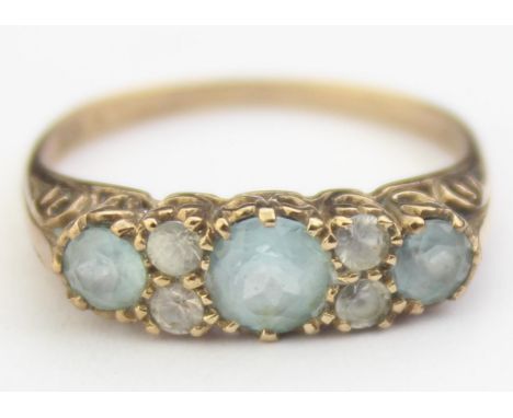 [2.31g, P] - a vintage 9ct gold ring set with three aquamarines separated by four small diamonds, in fancy scrolled setting, 