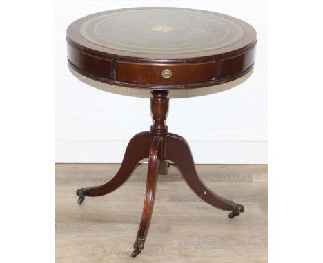 An antique style small drum or library table with inset green leather top, three drawers, 61cm wide x 68cm tall
