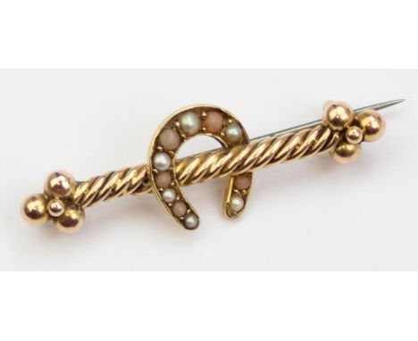 [2.59g] - an antique 15ct gold brooch set with seed pearls and formed as a lucky horse shoe, unmarked but XRF confirmed with 