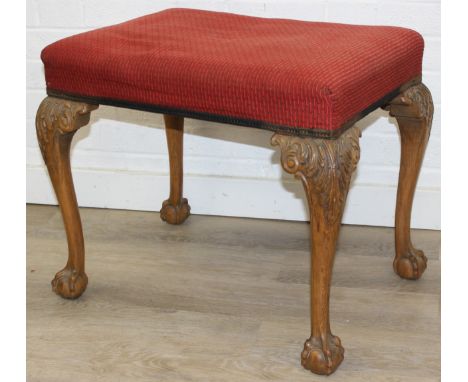 A vintage stool with cabriole legs and ball and claw feet, red upholstered top, 63cm x 47cm x 50cm