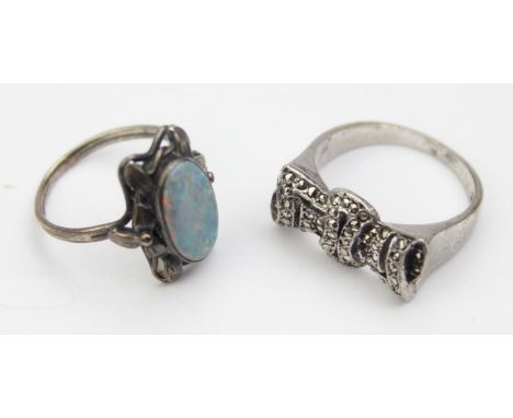 Two silver rings, one formed as a marcasite bow, the other set with a large oval opal, both XRF confirmed as silver, the bow 