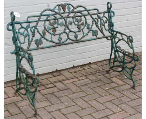 A vintage cast iron garden bench frame in the manner of Coalbrookdale, formed as swirling vines with layers of green paint, u