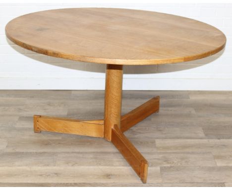 A modern light oak dining table with pillar support and tripod base, 124cm in diameter x 71cm tall
