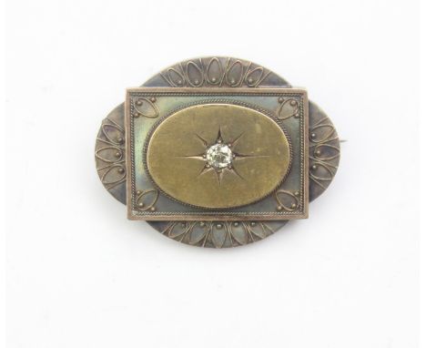 [11.11g] - a Victorian mourning brooch set with a diamond and filigree work, the central diamond assessed as 0.4ct, the mount