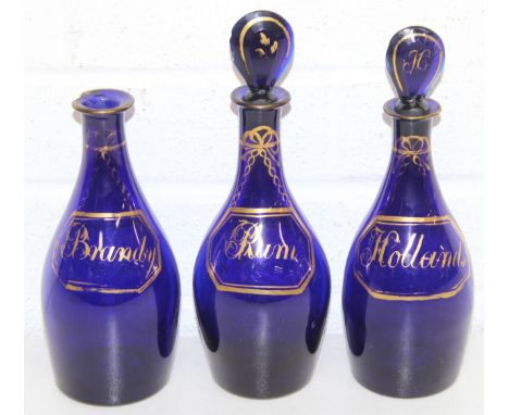 Three antique Bristol Blue decanter bottles in the manner of Isaac Jacobs with gilt decoration, labelled for 'Hollands', 'Bra