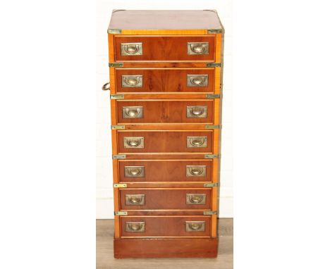 A modern yew wood effect campaign chest with seven drawers and recessed brass campaign style handles, 40cm x 31cm x 95cm