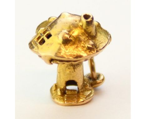 A vintage 9ct gold pendant or charm formed as a toadstool which opens to reveal a figure eating a meal, XRF confirmed, 3.44g,