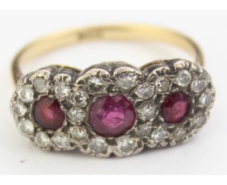 [4.66g, R] - an antique 18ct gold ruby and diamond ring, three central rubies assessed as 0.35ct flanked by two of 0.15ct (0.