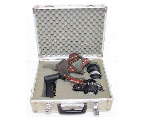 Vintage Nikon camera items to incl camera, auto f=135mm lens, and MD-12 motor drive, in aluminium case