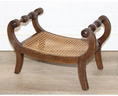 A small antique mahogany footstool with scroll arms and bergere top, 44cm x 26cm x 29cm