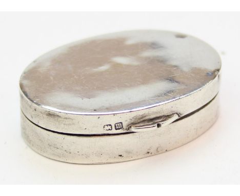 An early 20th century silver pill or snuff box of plain form with gilt lined interior, marked for Birmingham 1911, makers mar