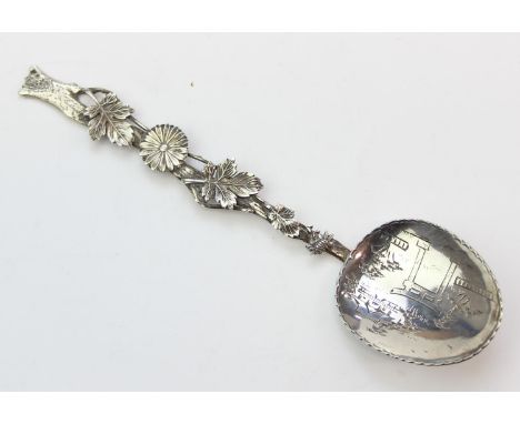 A Japanese Sterling silver spoon with engraved with Buddhist motifs to bowl and a chrysanthemum and leaves to handle, marked 